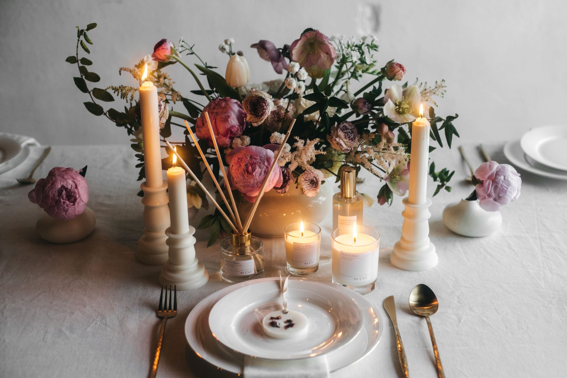 Aroma de peonías para boda. Mesa decorada con velas, difusores y candelabros.